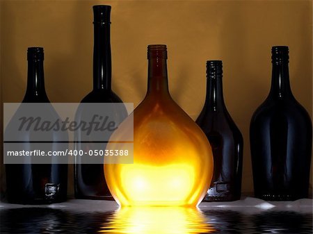 few glass bottles, one of them is lighted