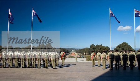 australian soldiers standing, waving australian flags, Canberra Parliament House in background