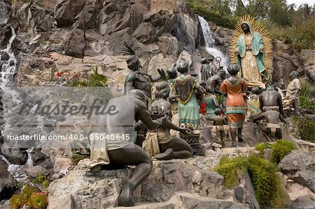 Statue of Virgin Mary, Guadalupe, Appearing to Juan Diego, Indians and Bishop, Guadalupe Shrine, Mexico.  This statue is located at one of the locations that the Virgin Mary allegedly appeared to Juan Diego.