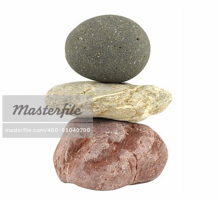 Pile of balanced stones representing meditation isolated in white