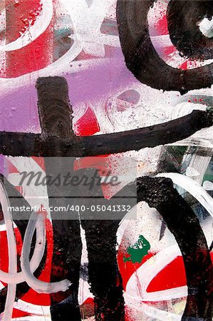 A surface covered with layers of graffiti and tags.