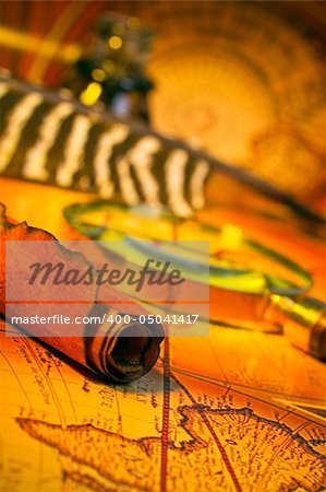 Magnifying glass, quill, scroll, and map with antique look