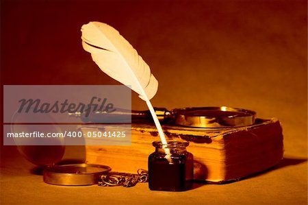 Quill, inkwell, compass, book with an antique look