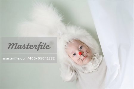 Child in a white downy bunny costume.