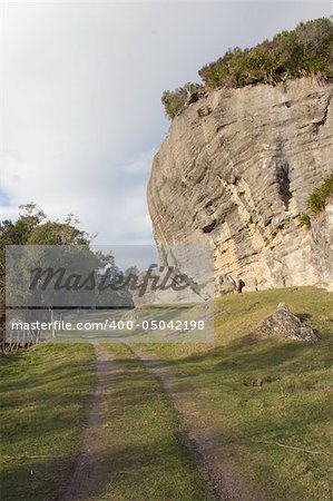 A country road winds around wind eroded limestone cliffs