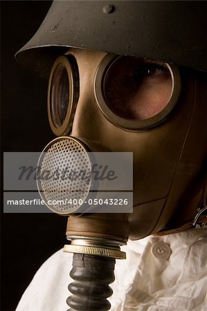 Person in gas mask on dark background