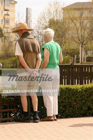 elderly couple looking into the lake