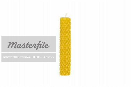 Yellow honeycomb candle on isolated white background
