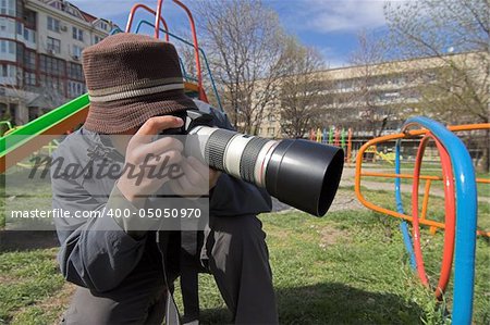 Young photographer with big zoom lens