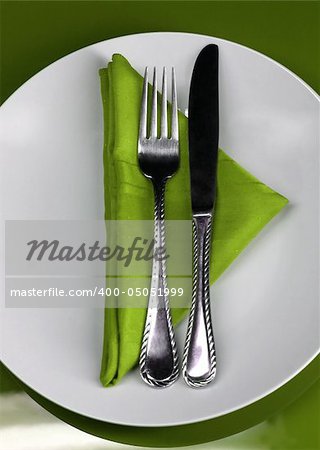 A modern restaurant table setting in green