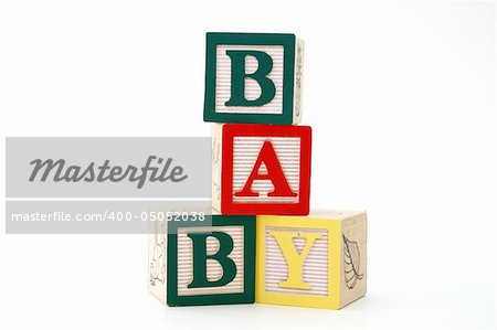 word baby formed by alphabet wood blocks on a white surface