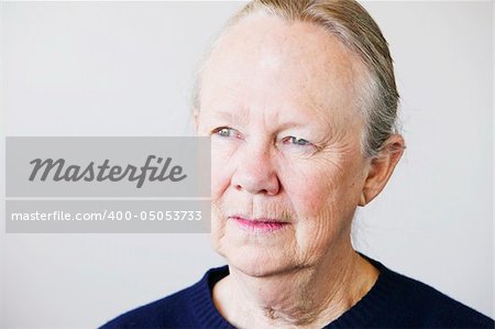 Portrait of a senior woman looking towards a light source.