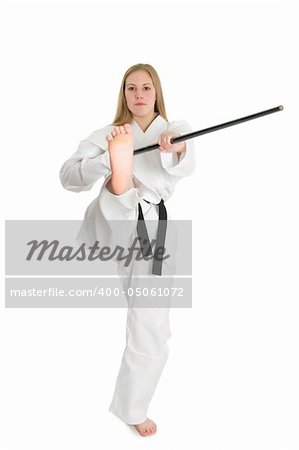 Black belt female martial artist doing front kick and bo (staff) strick.