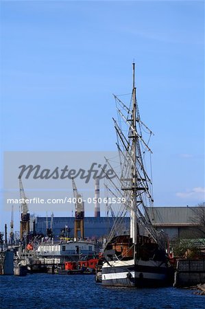 Sailing ship at the port take off mast. River Neva, Saint-Petersburg, Russia.