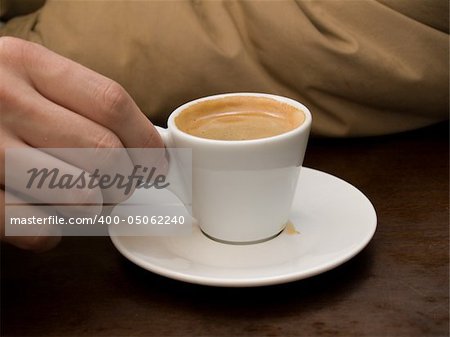 Man's hand with the cup of espresso