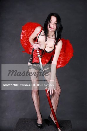 Nasty angel with red wings, sword, leather dress and pantyhose