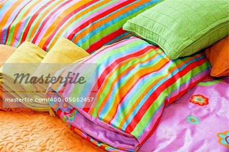 Colorful bedding pillows and blankets with straps