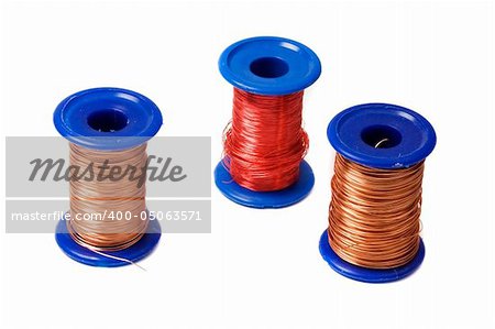 Three reels with copper wire isolated on white background