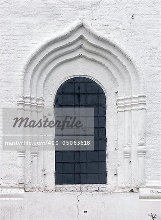 Old window in a wall of a monastery