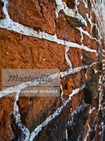ancient weathered bricked wall. Focus on a nearest stones.