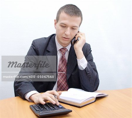Businessman accounting balance data on calculator