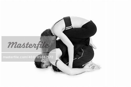 Male and female gymnasts practicing a complex double yoga pose.