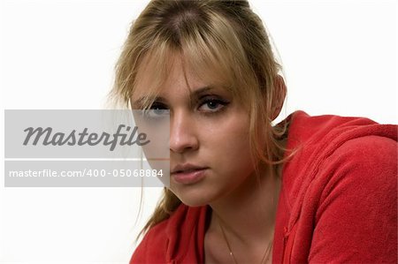 Landscape portrait of an attractive serious blond woman with hair in ponytail in red sweatshirt