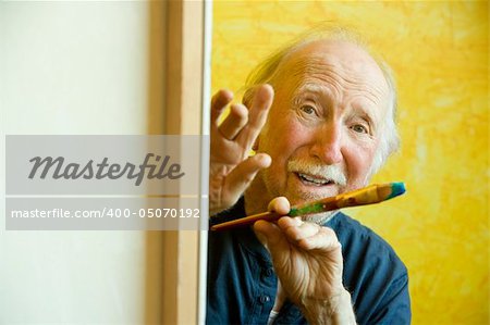 Elderly painter working on a large canvas