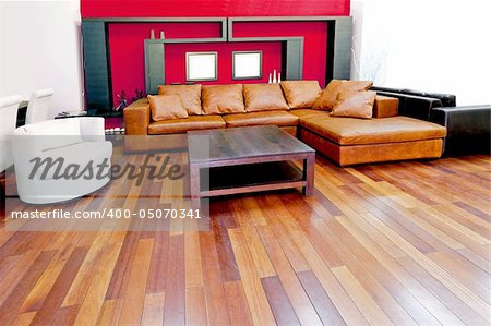 Red living room with brown leather sofa