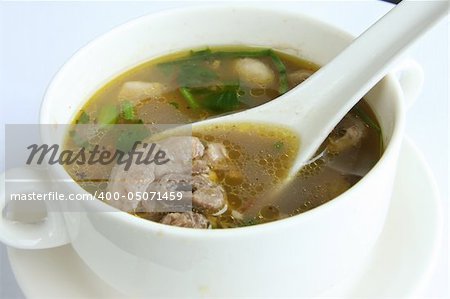 Spicy oxtail soup with vegetables in white bowl