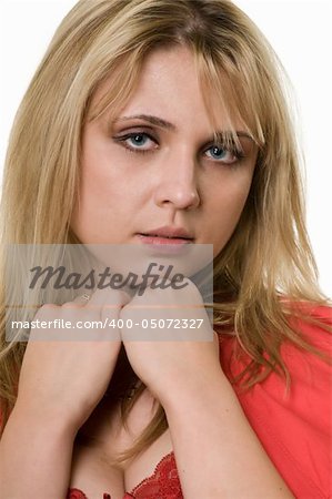 Close up of face of an attractive blond woman with chin on hands over white