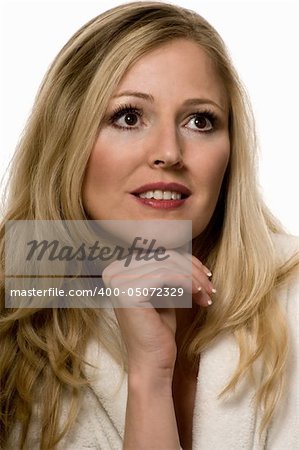 Beautiful portrait close up of a blond woman with brown eyes wearing makeup with chin on hand over white