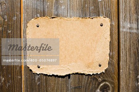 Torn Cardboard On Wooden Wall. Ready For Your Message.