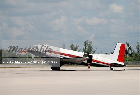 Old propeller driven airplane on a runway