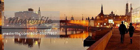 panoramic photo of a night city on a bank of a river