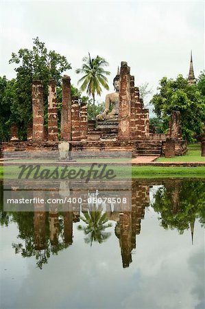 buddha statue reflected in lake water, sukothai historical park, thailand