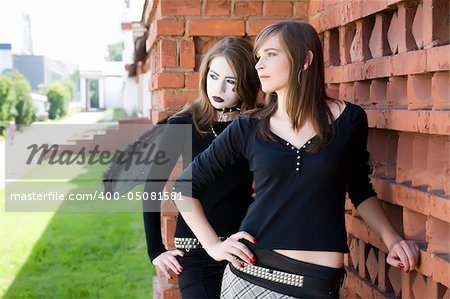 Girls Near A Brick Wall