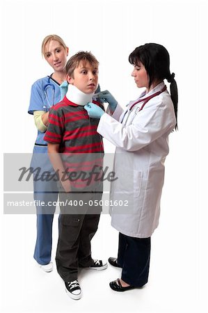 Medical personnel apply a cervical collar to  the neck of an injured boy