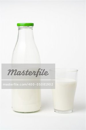 pouring fresh glass of milk isolated over white