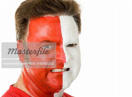 Closeup portrait of an aggressive sports fan wearing face paint.