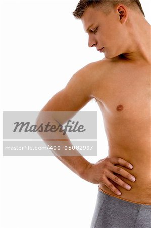 man looking at his muscular arm against white background