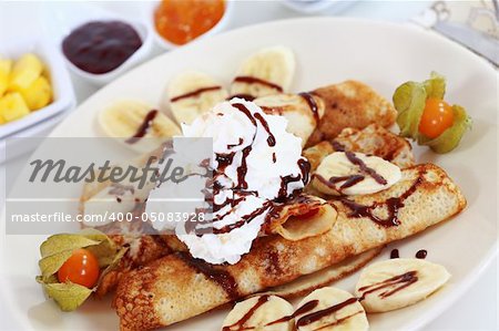 Delicious crepes with fruits and chocolate