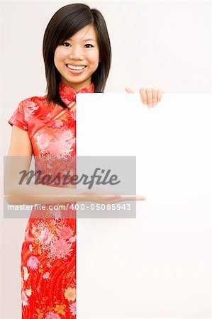Oriental girl wishing you a happy chinese new year, with copy space.