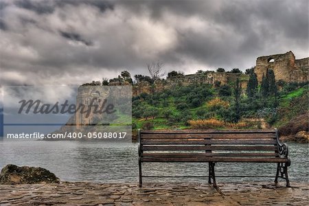 Picture of the venetian castle of Koroni in southern Greece, with a bench in the foreground.