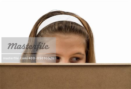 Young girl peeking over the edge of an office wall