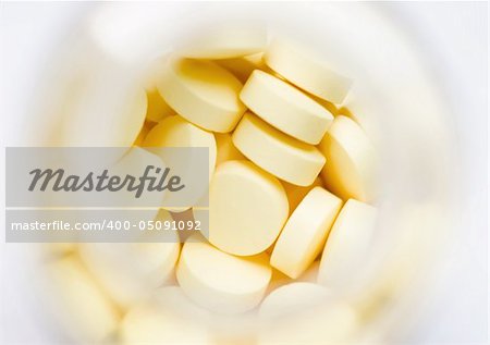 Yellow pills over white macro shot