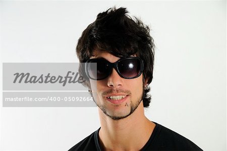 Portrait of young trendy hispanic man wearing sunglasses isolated
