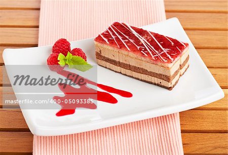 Delicious strawberry cake with soft shadow on white dish. Shallow depth of field