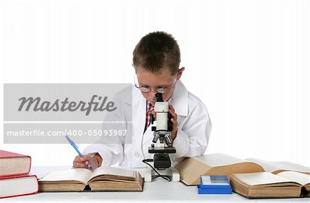 young boy in lab coat and glasses looking through microscope and taking notes