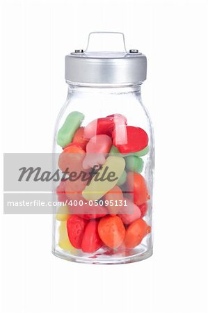 Colorful candies in the glass jar isolated on white background